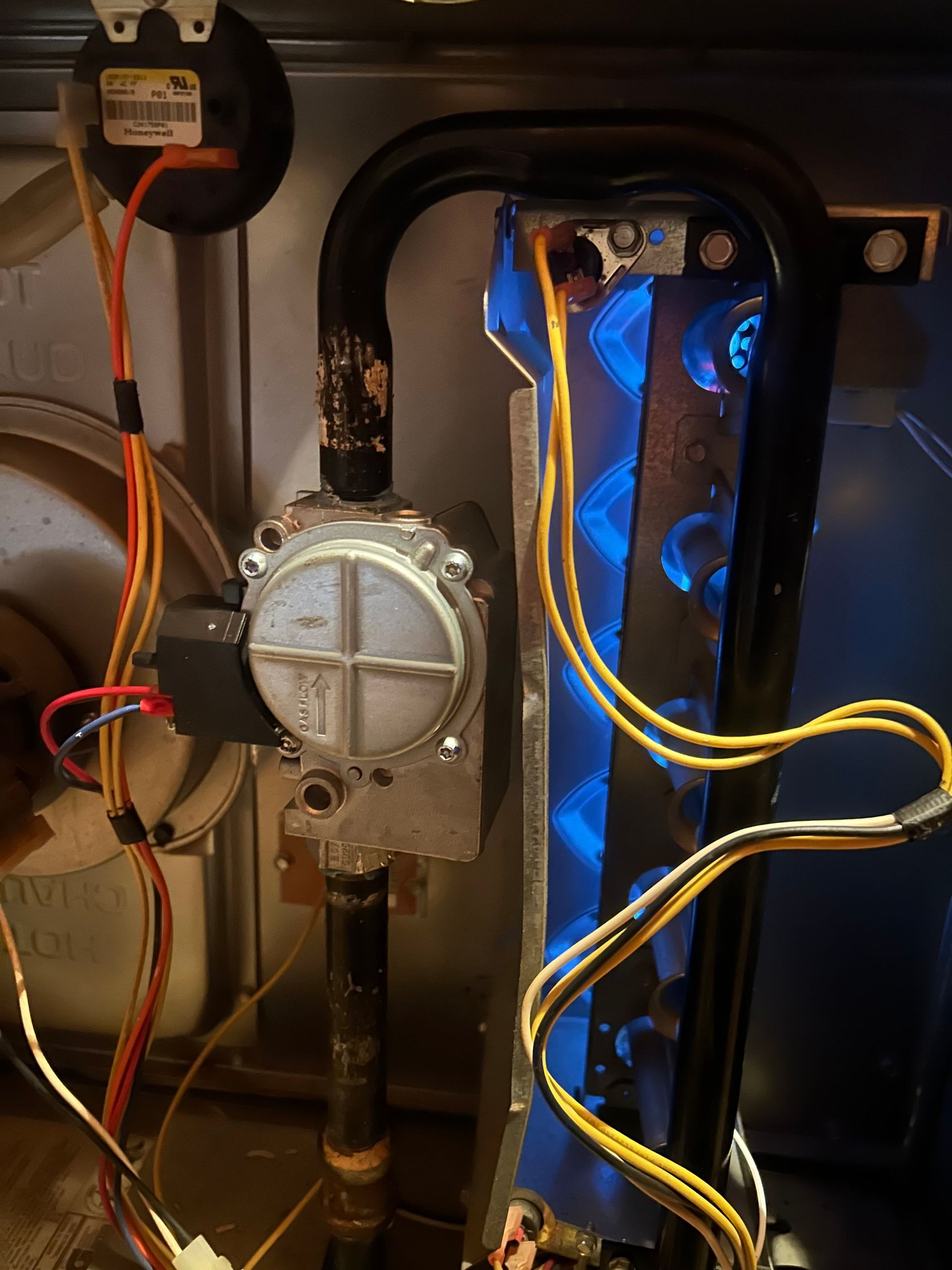 A close up of a stove with wires coming out of it