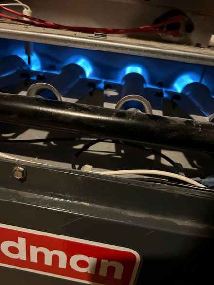 A coleman heater with blue lights on it