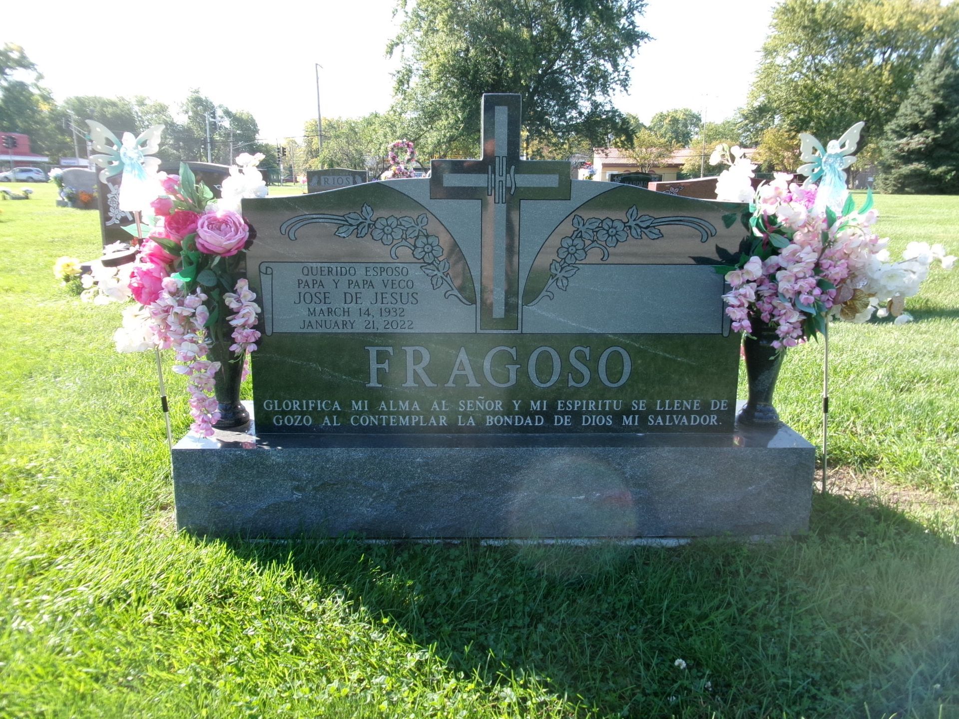 A dark gray granite tombstone engraved with 