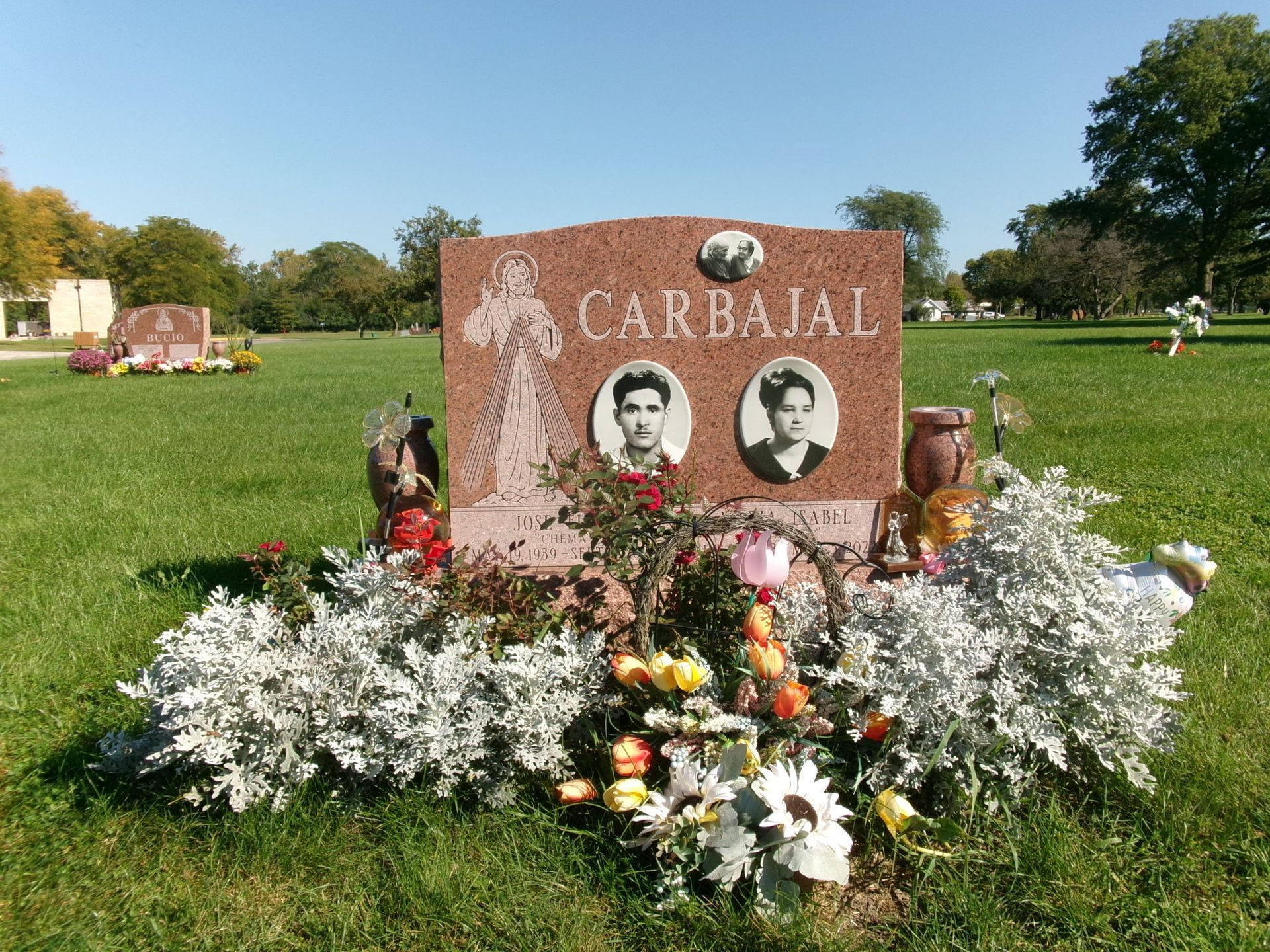 A pink granite tombstone marked 