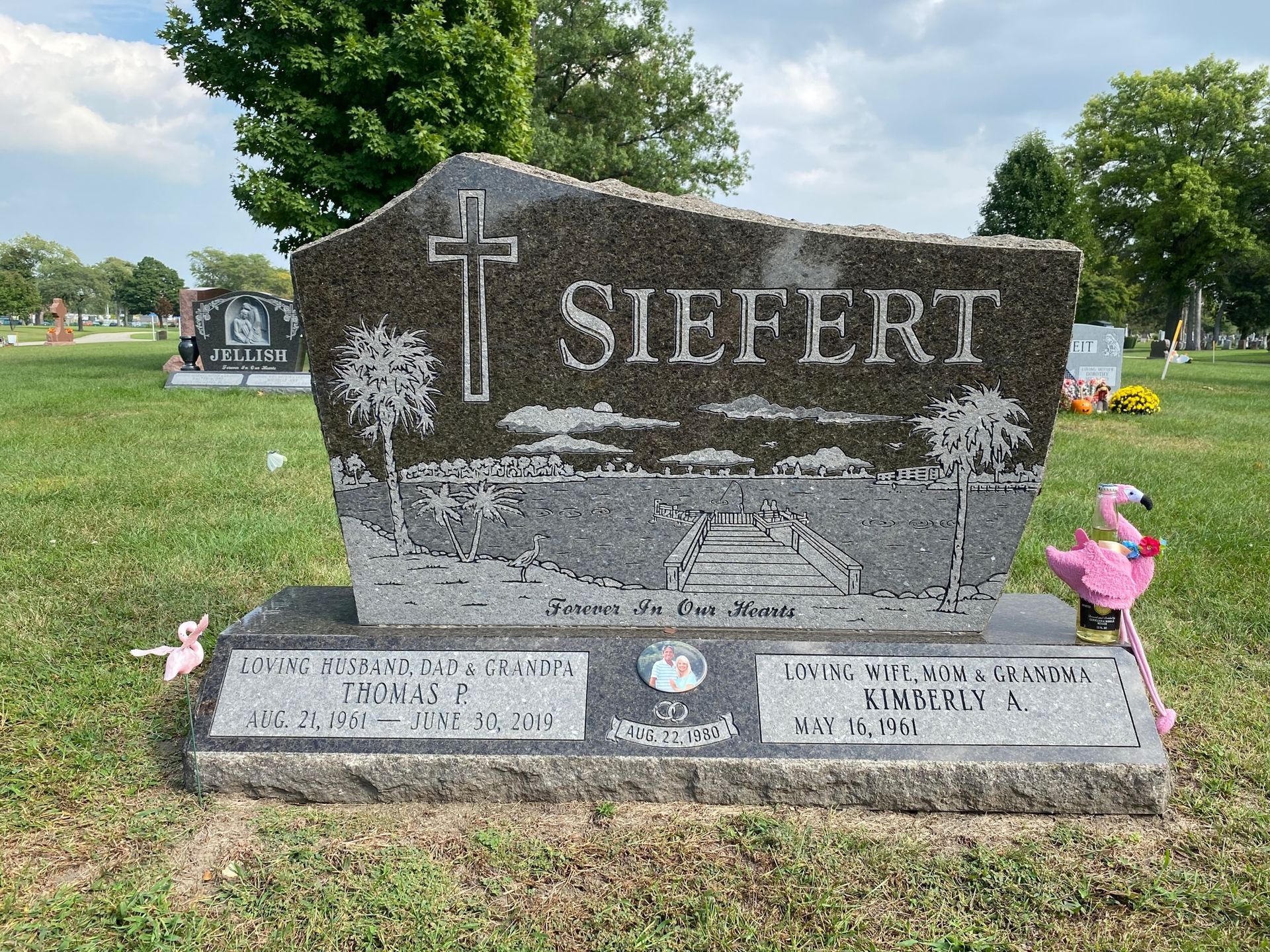 Tombstone engraved with POWER, flanked by flower vases in a grassy cemetery setting Tombstone engraved with POWER, flanked by flower vases in a grassy cemetery setting.