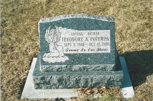 Headstone with angel carving; inscription for Theodore A. Potempa (1916-2001), on a gray stone base.