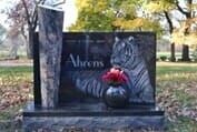 Headstone with etched tiger, name 