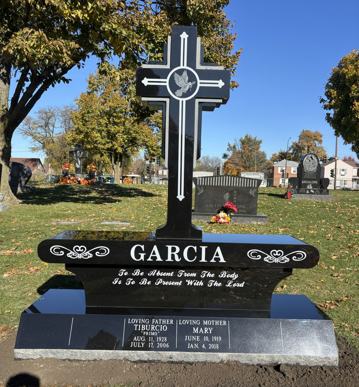 Cemetery headstone shaped like two crosses, etched floral design,