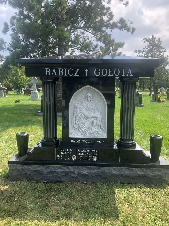 White flatbed truck with crane parked on gravel.