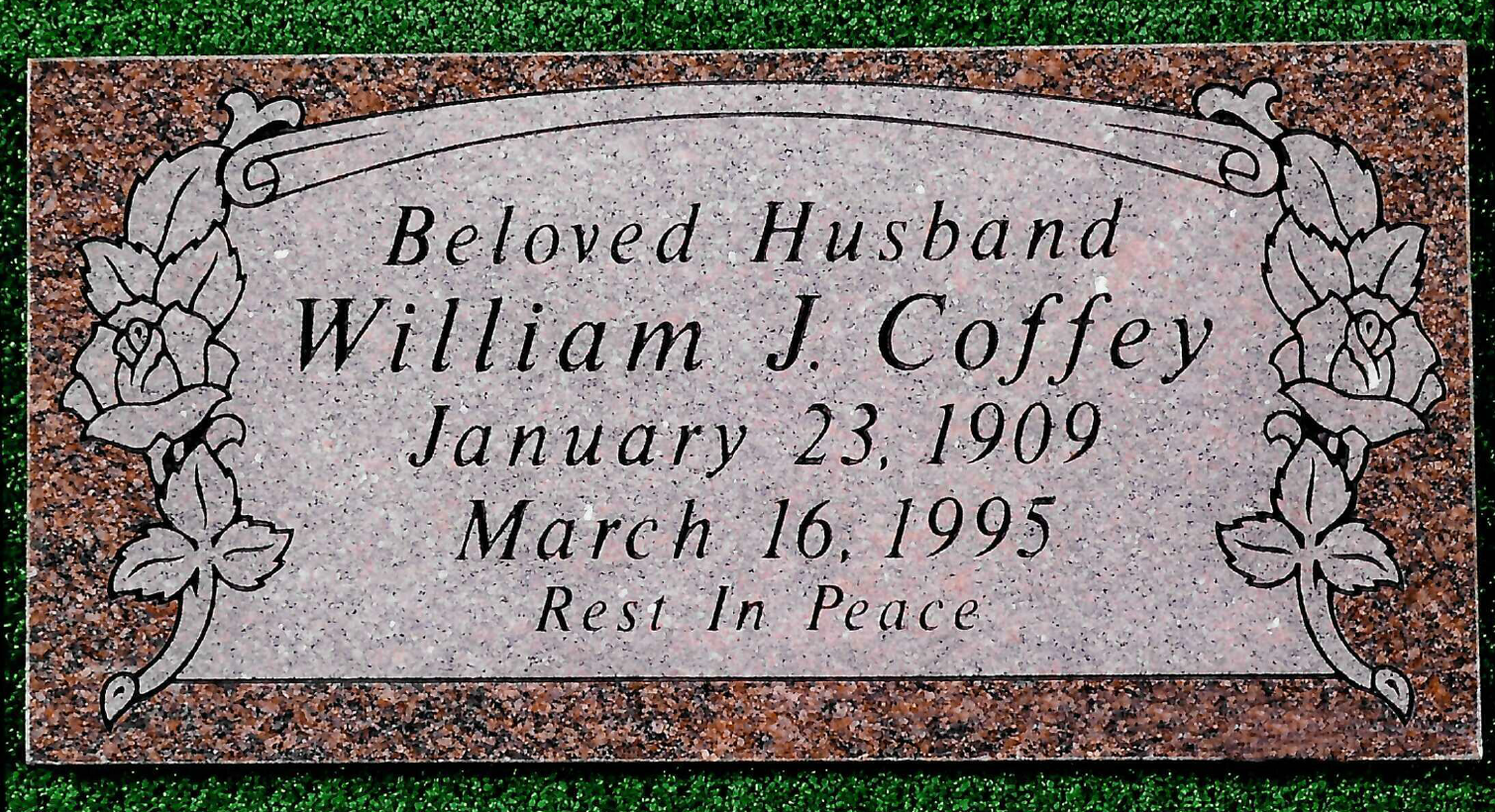 A reddish-brown granite headstone for William J. Coffey, with floral carvings on the sides and 
