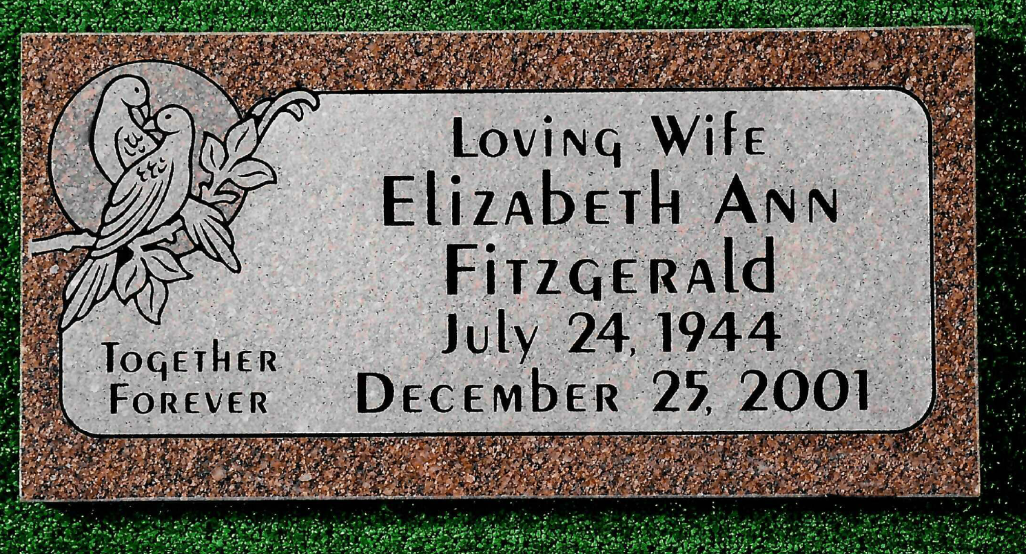 Granite grave marker for Elizabeth Ann Fitzgerald, born July 24, 1944, died December 25, 2001, with dove imagery.