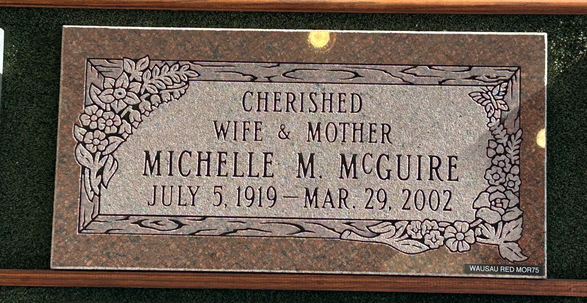 Bronze plaque on a stone base, commemorating Captain Nathan Olney in a field setting.