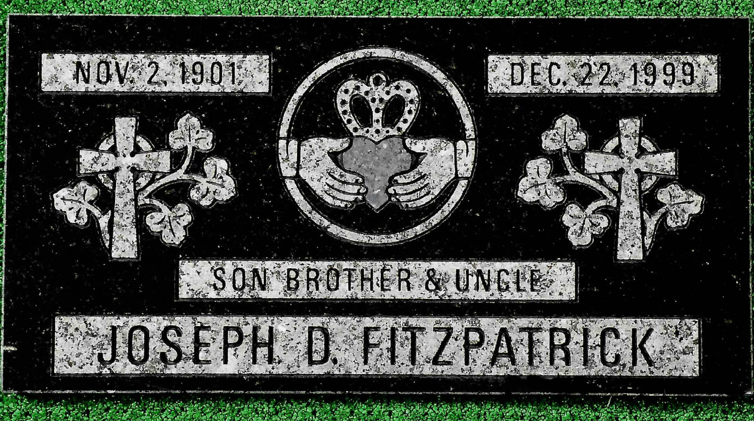 A black granite grave marker for Joseph D. Fitzpatrick, featuring a Claddagh symbol, two Celtic crosses, and dates.