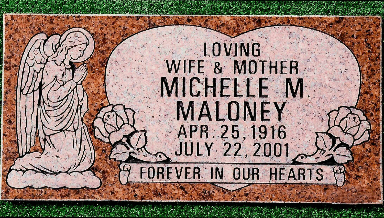 A rectangular reddish-brown granite headstone with a praying angel on the left, two roses, and an engraved heart shape.