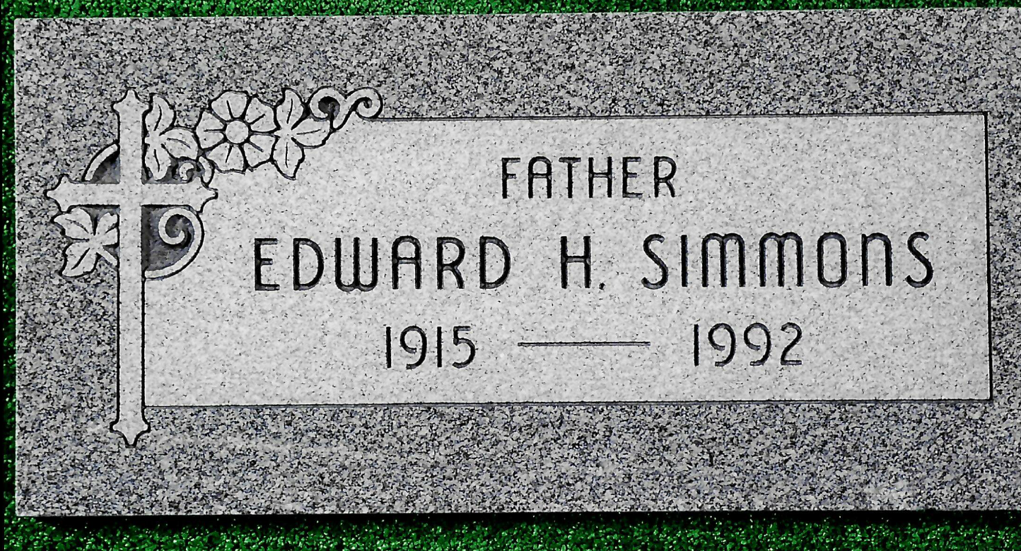 A grave marker for Edward H. Simmons (1915-1992) with a cross and floral design on the left side.