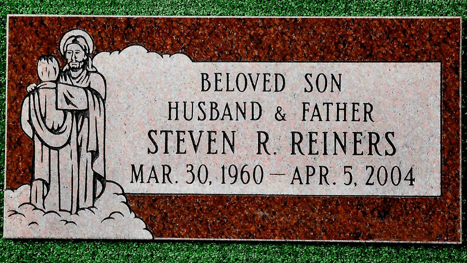 A rectangular red granite grave marker for Steven R. Reiners (1960–2004) featuring an etching of Jesus with a figure.