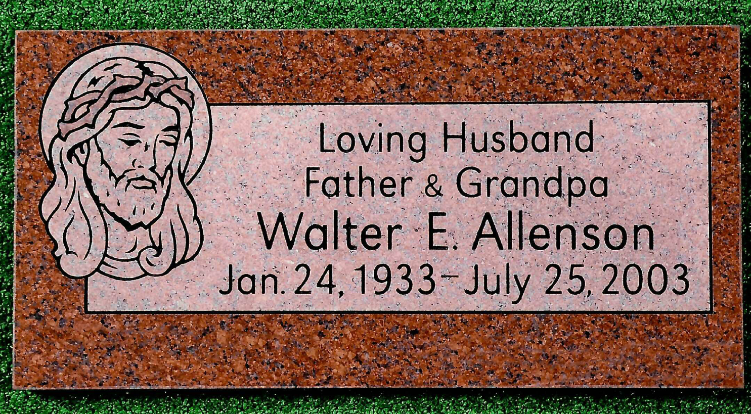 A red granite grave marker for Walter E. Allenson (1933-2003) featuring an etching of Jesus with a crown of thorns.