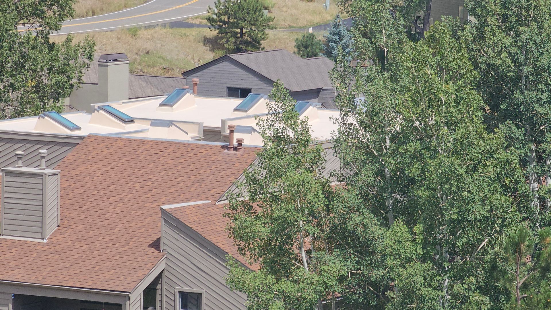 A person is using a drill to install a wooden fence.