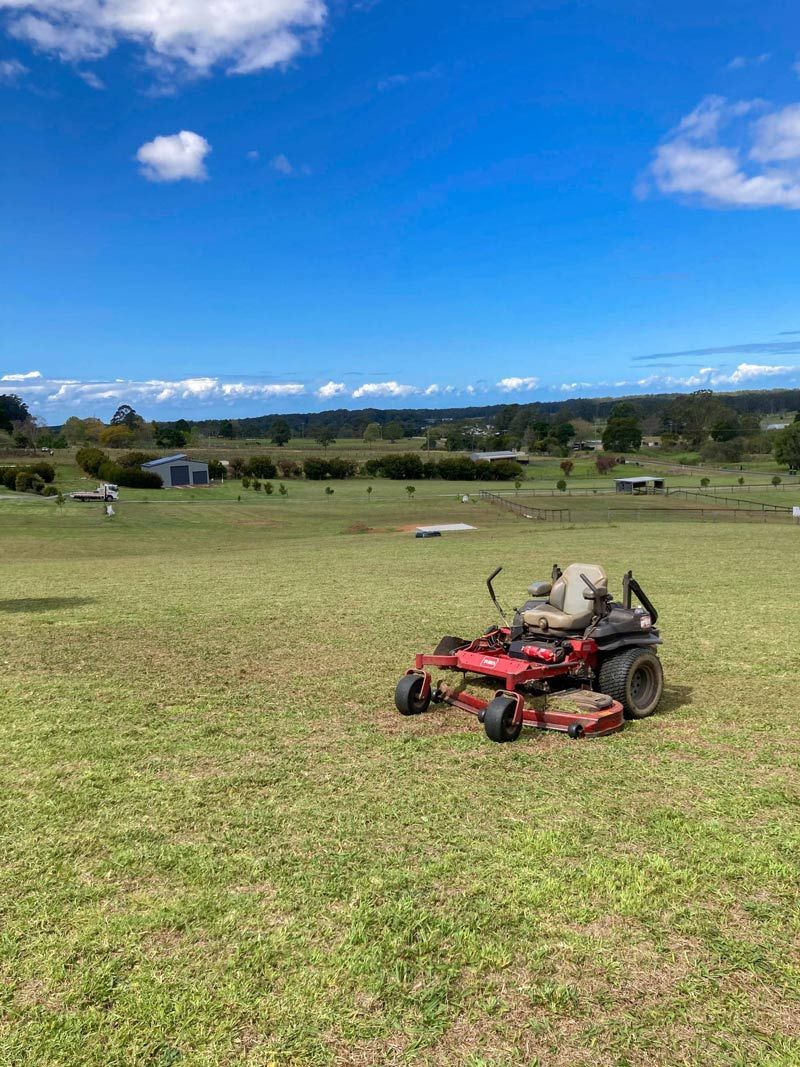 Lawnmower Trimming A Large Landscape Lawn — All Assist In Nana Glen NSW