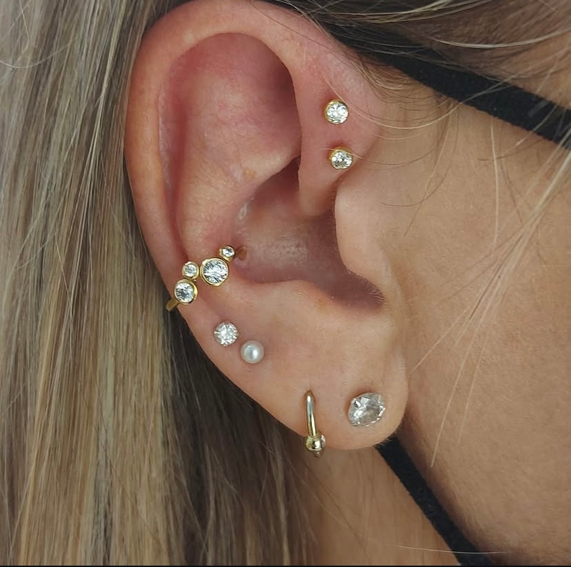 female with multiple ear piercings