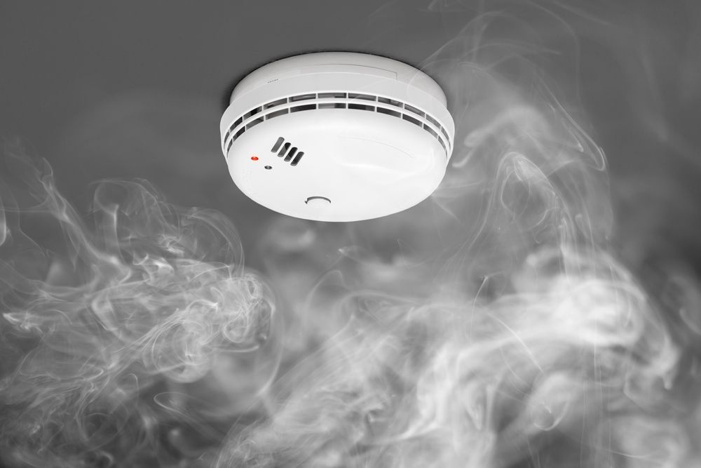 A Smoke Detector is Surrounded by Smoke Coming Out of It — Brite-Lec Pty Ltd in Currajong, QLD