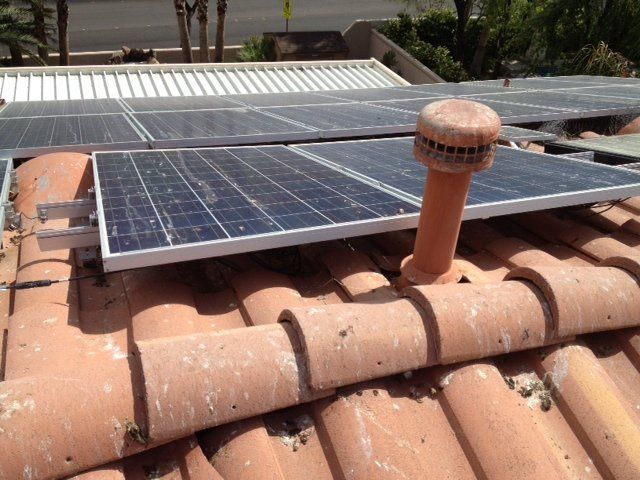 Pigeons nesting under solar panels