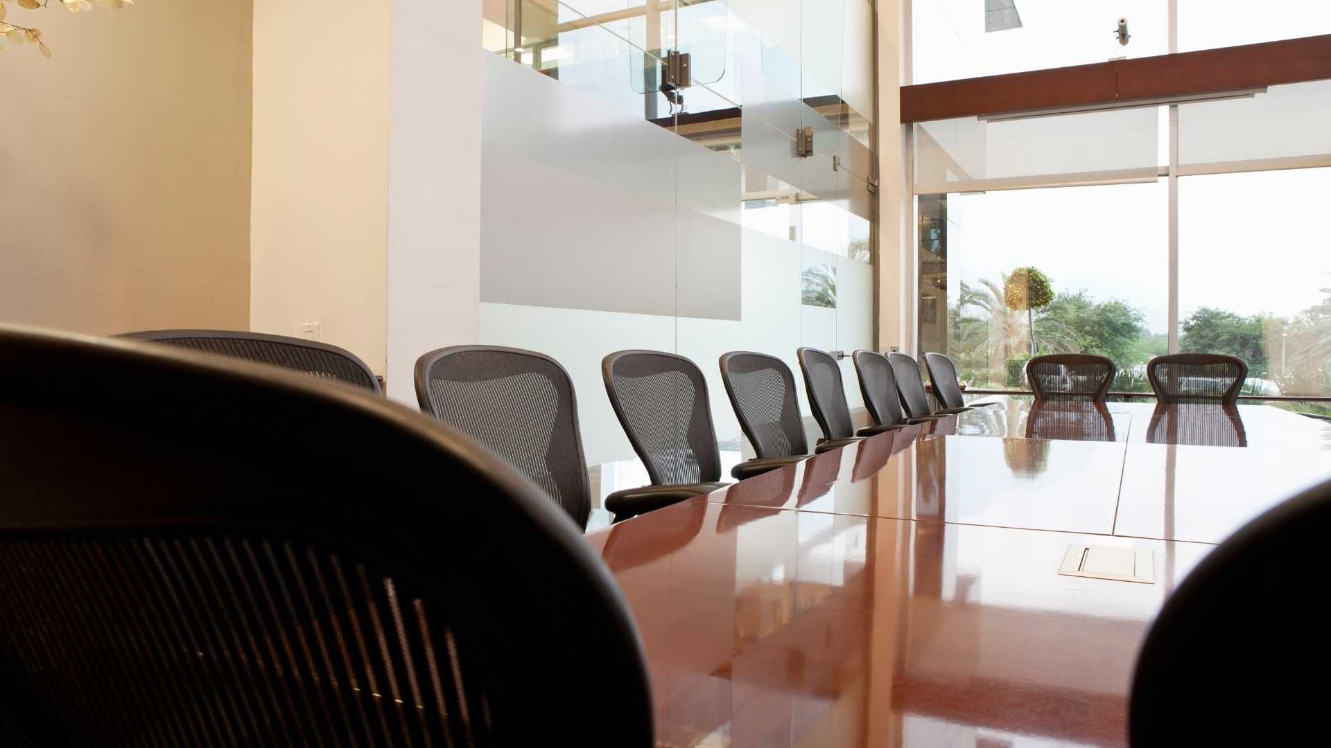 A conference room with a long table and chairs