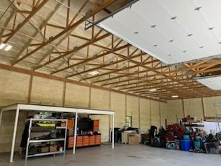 A large garage filled with lots of tools and boxes.