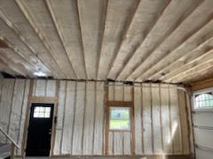 A garage with a ceiling and walls covered in insulation.