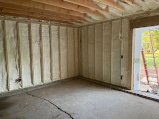 A room with a door and a lot of insulation on the walls.
