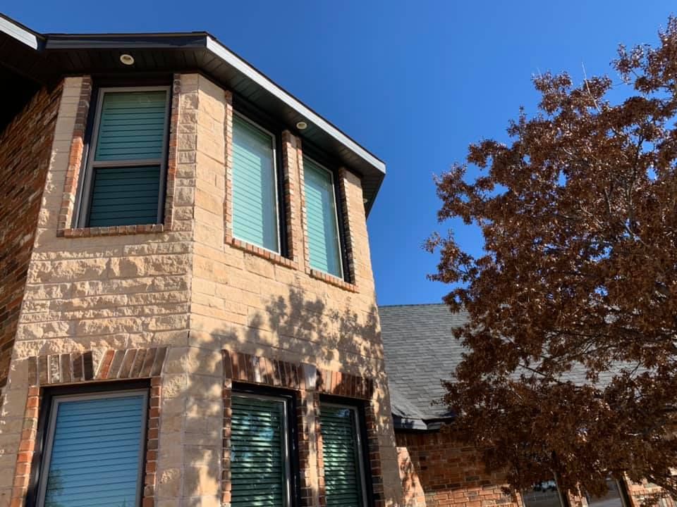 A brick building with a tree in front of it