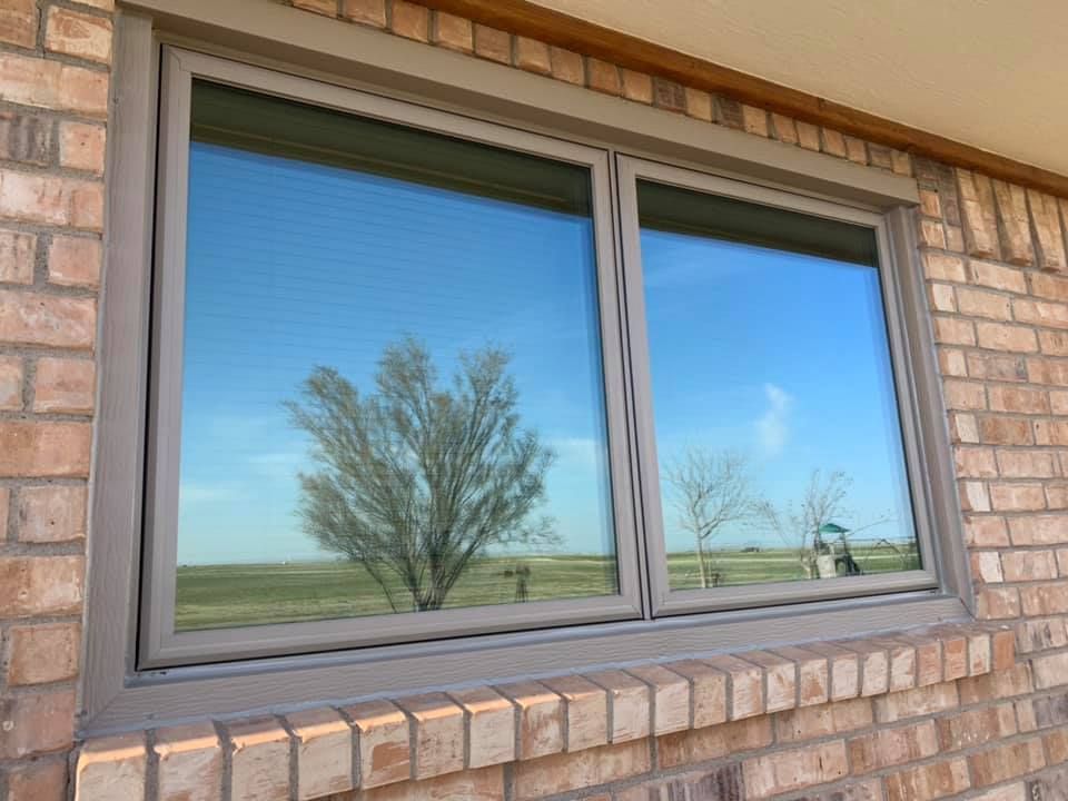 A large window on the side of a brick building.