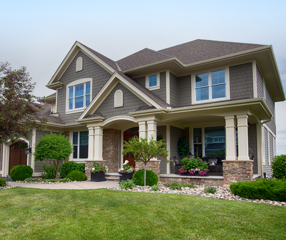 A large house with a lush green lawn in front of it