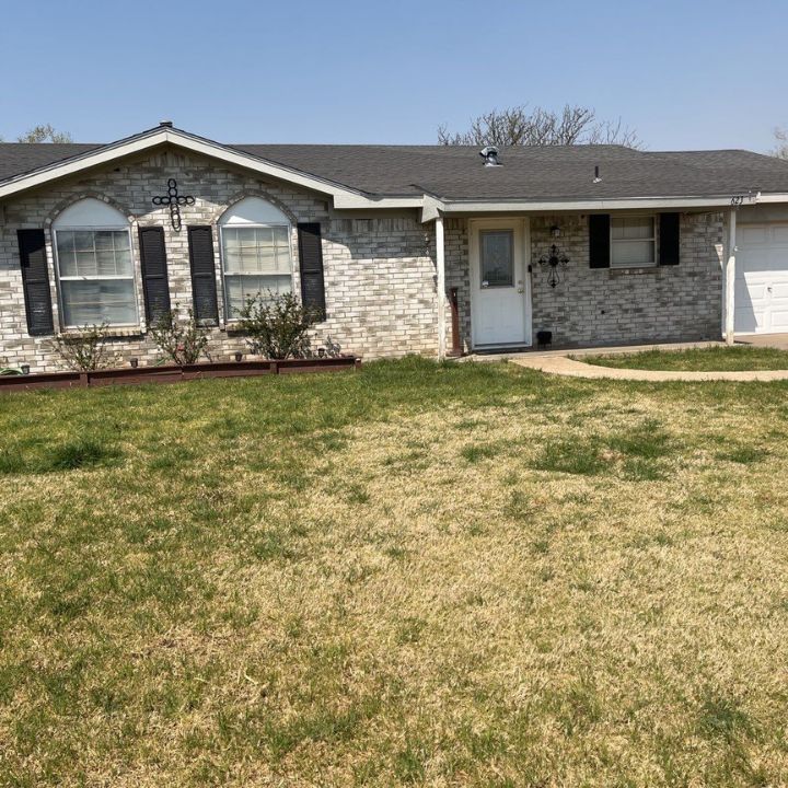 A house with a lot of grass in front of it