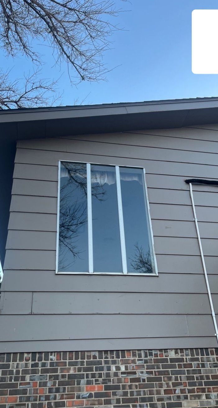 A house with a large window on the side of it.