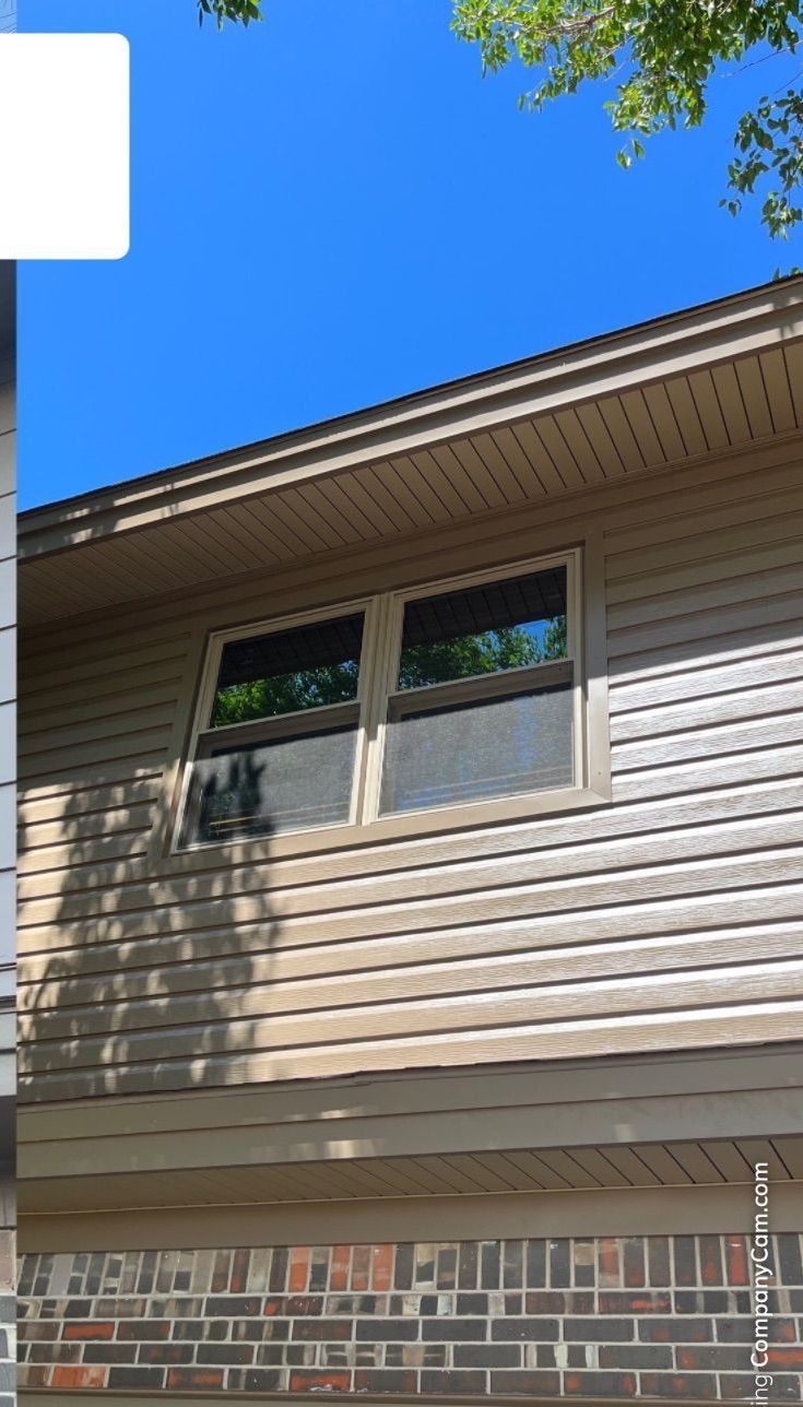 A house with a lot of windows and a blue sky in the background