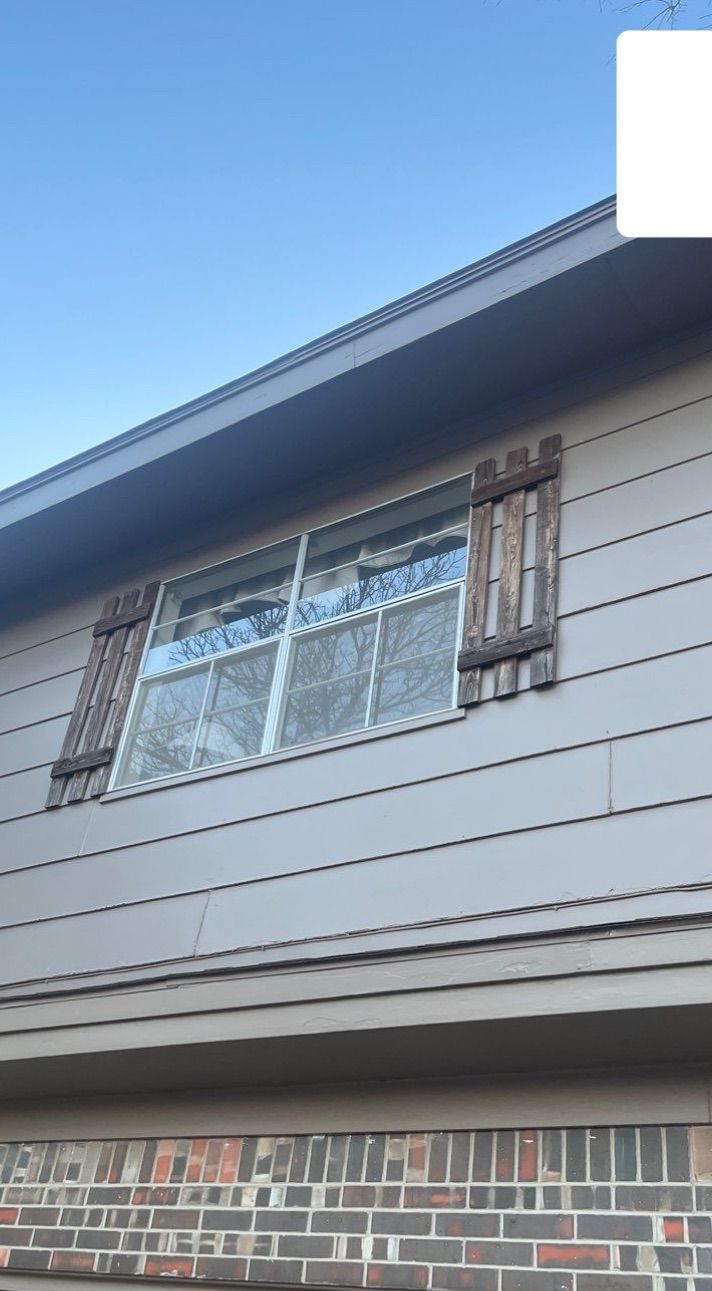 A house with a window with wooden shutters on it
