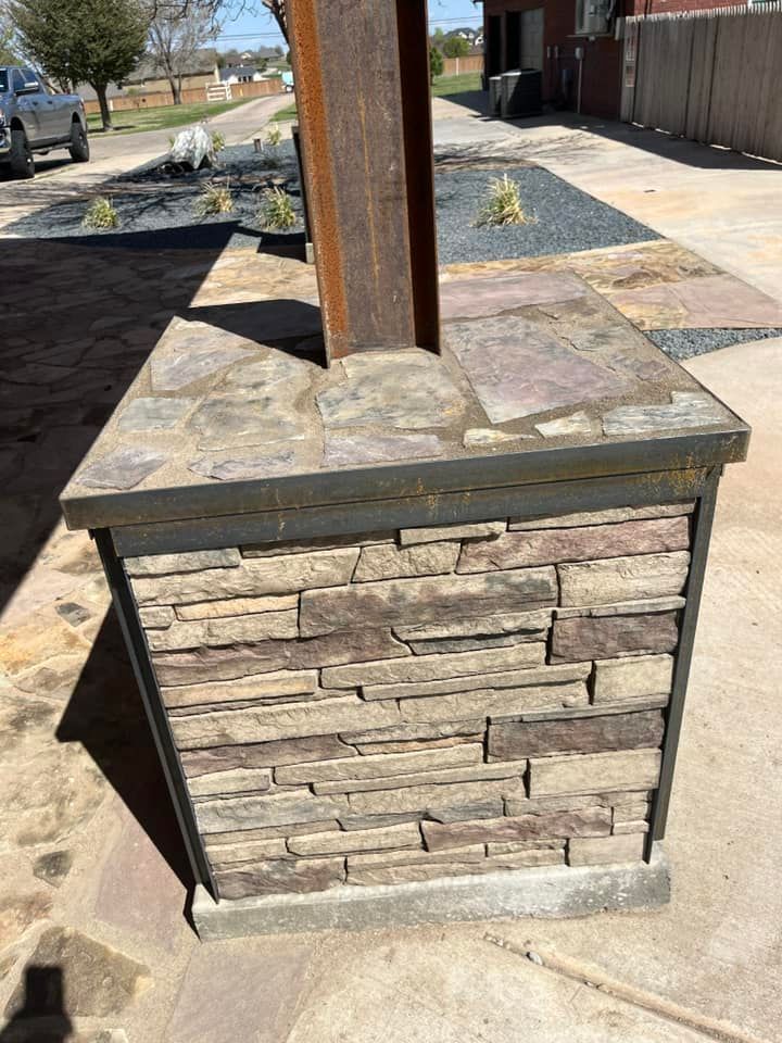 A stone pillar is sitting on the side of a road.