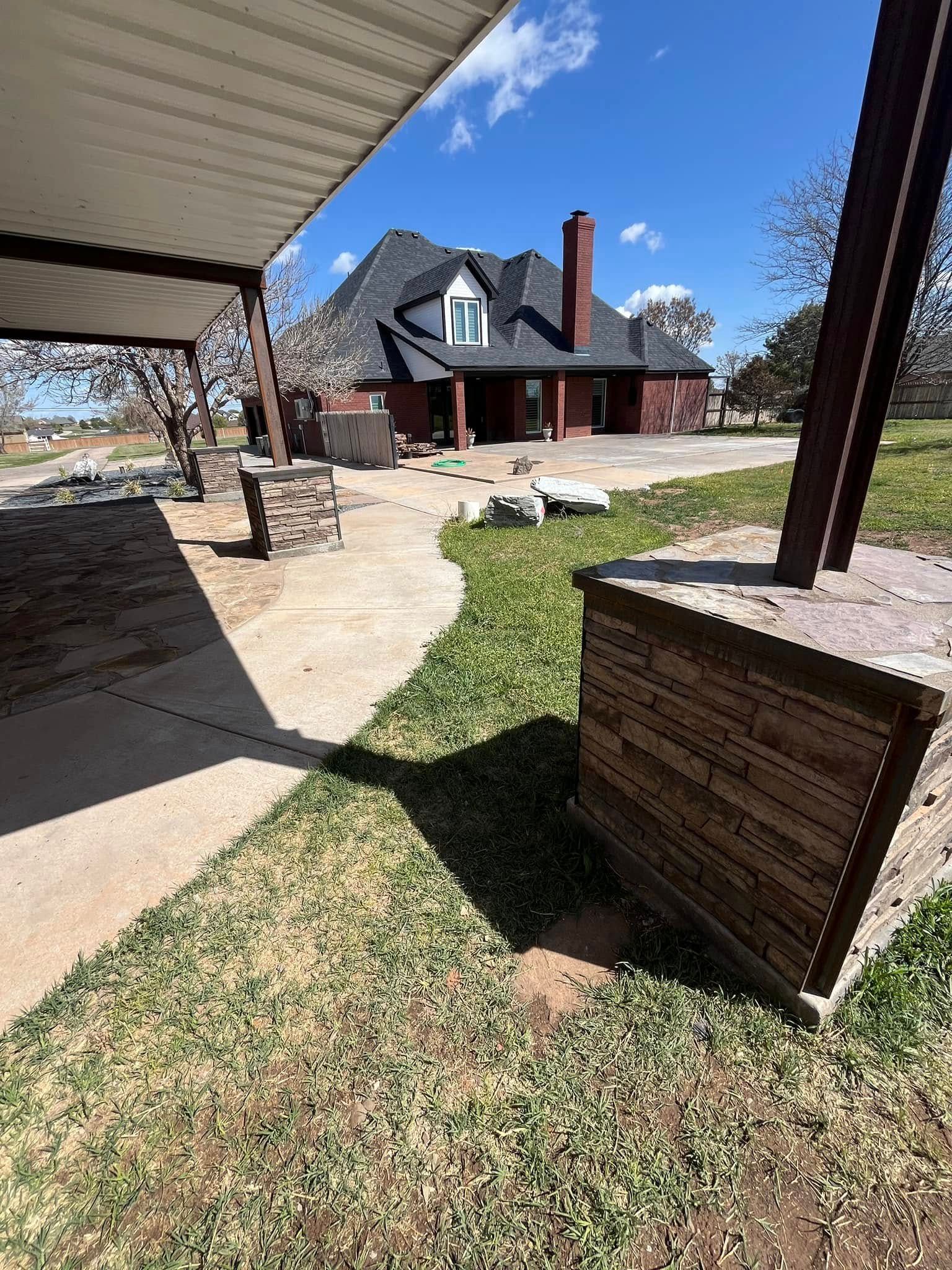 A house with a covered porch and a well in front of it.