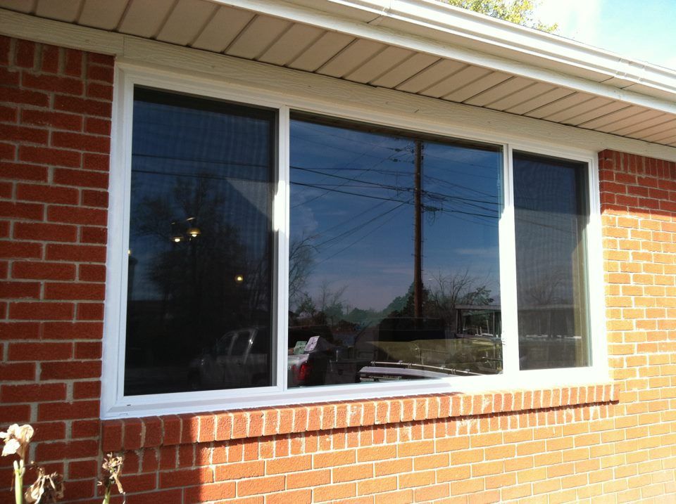 A brick house with a large window on the side