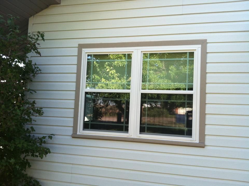 A white house with a window on the side of it