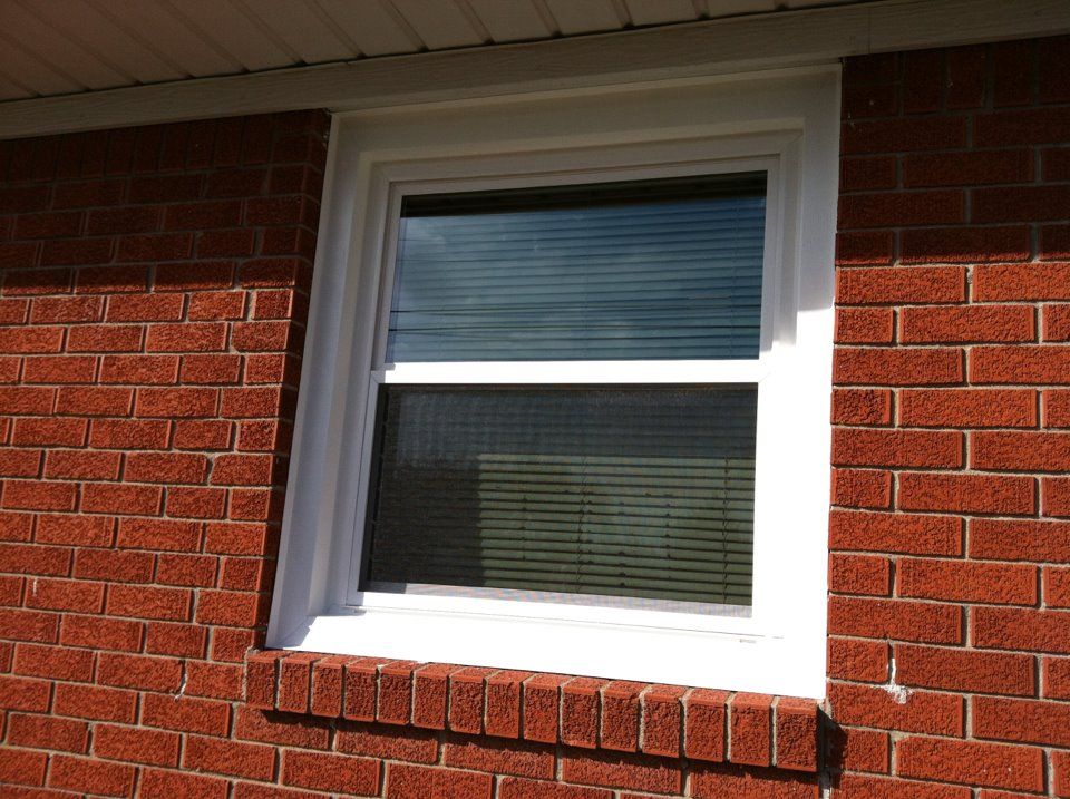 A red brick building with a white window