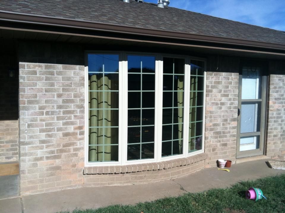 A brick house with a large bay window