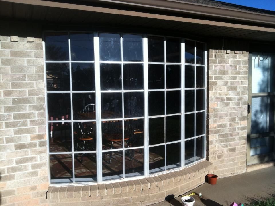 A large window on the side of a brick house