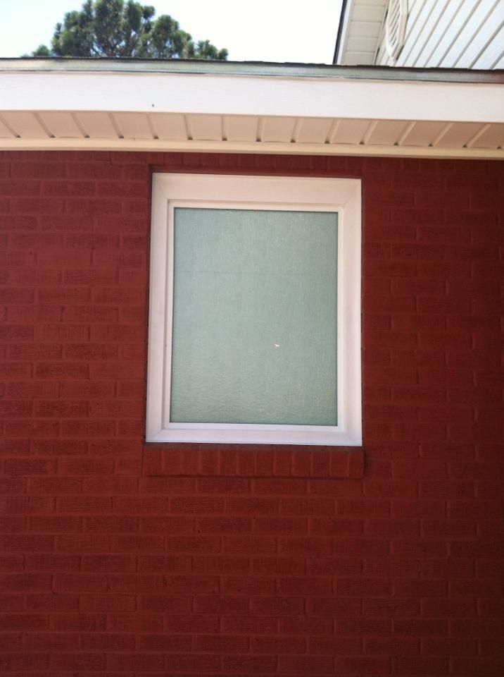 A red brick building with a white window
