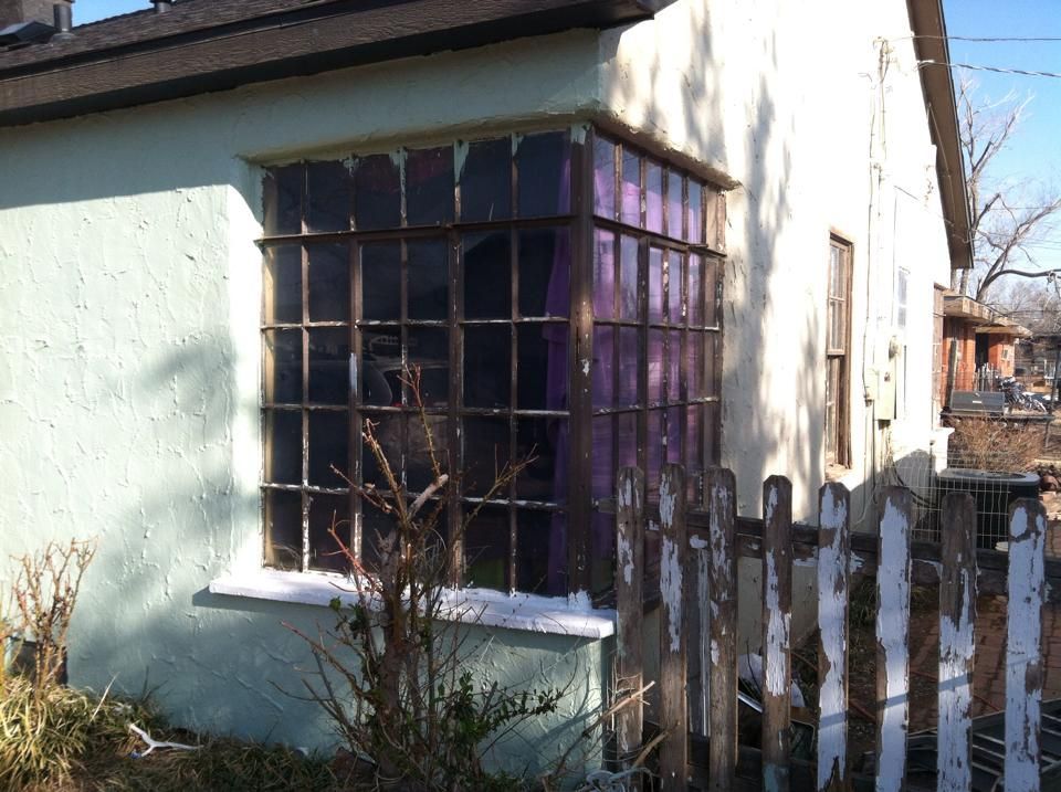 A small house with a fence and a window