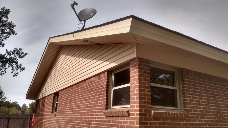 A brick house with a satellite dish on the roof