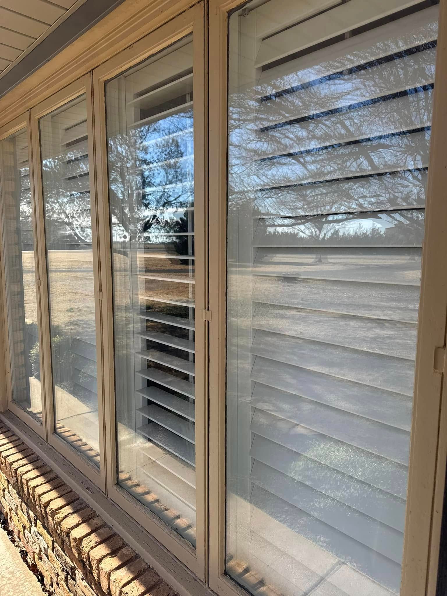 A row of sliding glass doors with shutters on them.