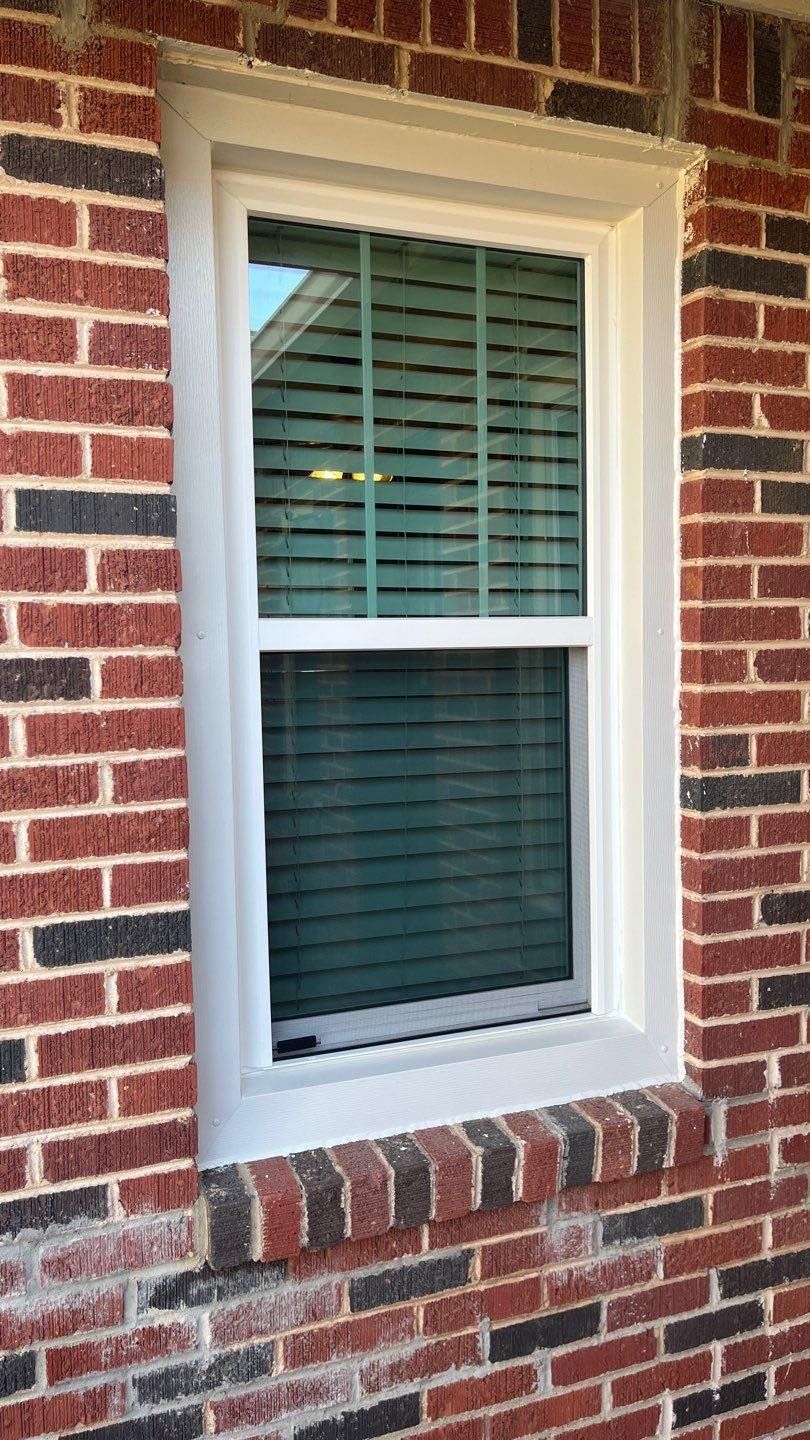 There is a window on the side of a brick building.