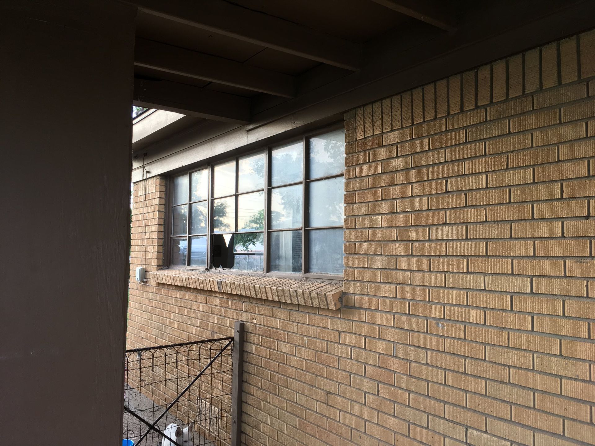 A brick building with a large window on the side of it.