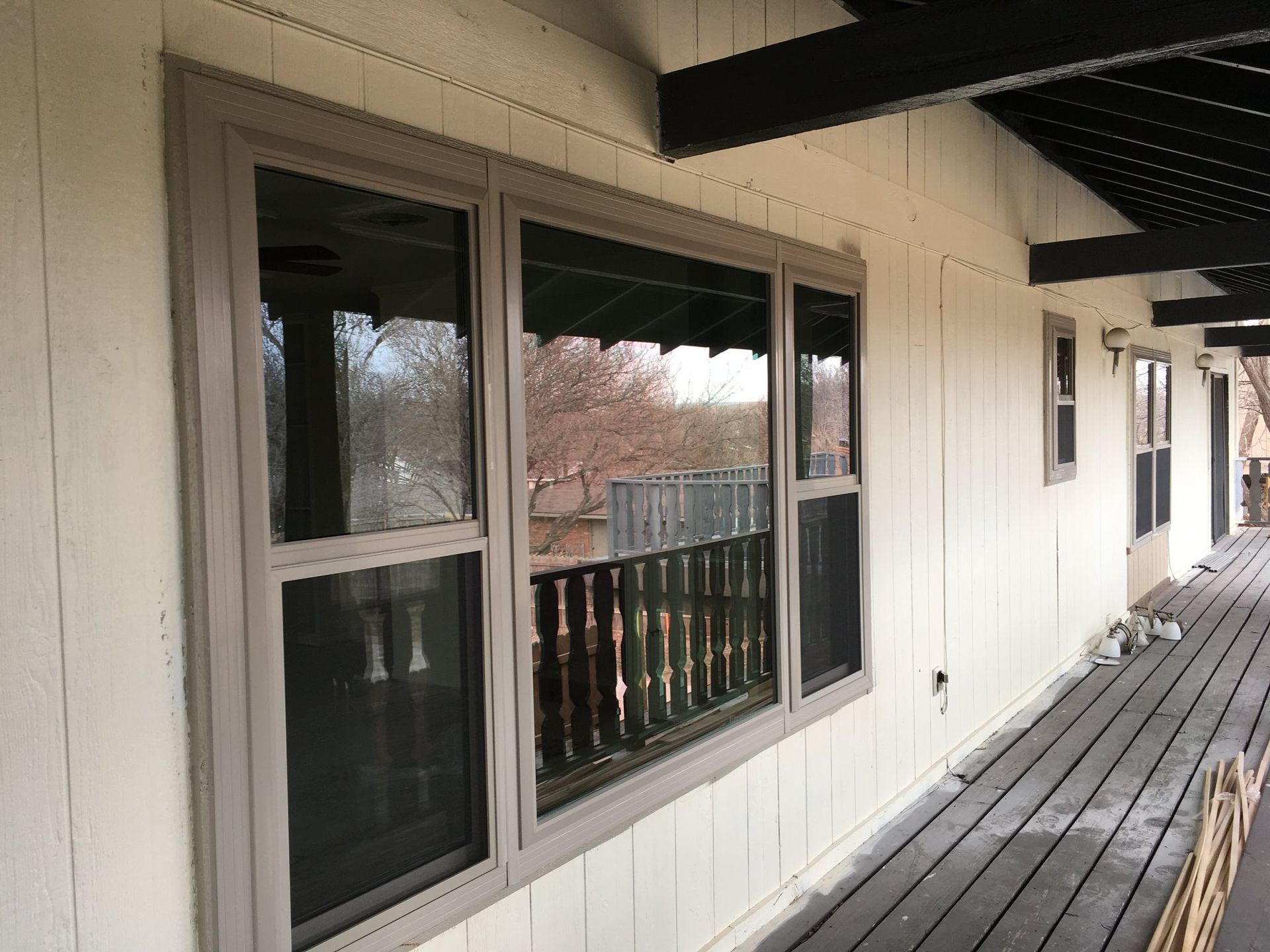 There are many windows on the side of a house.