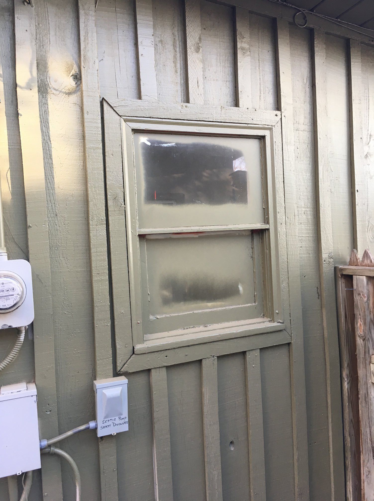 There is a window on the side of a building.