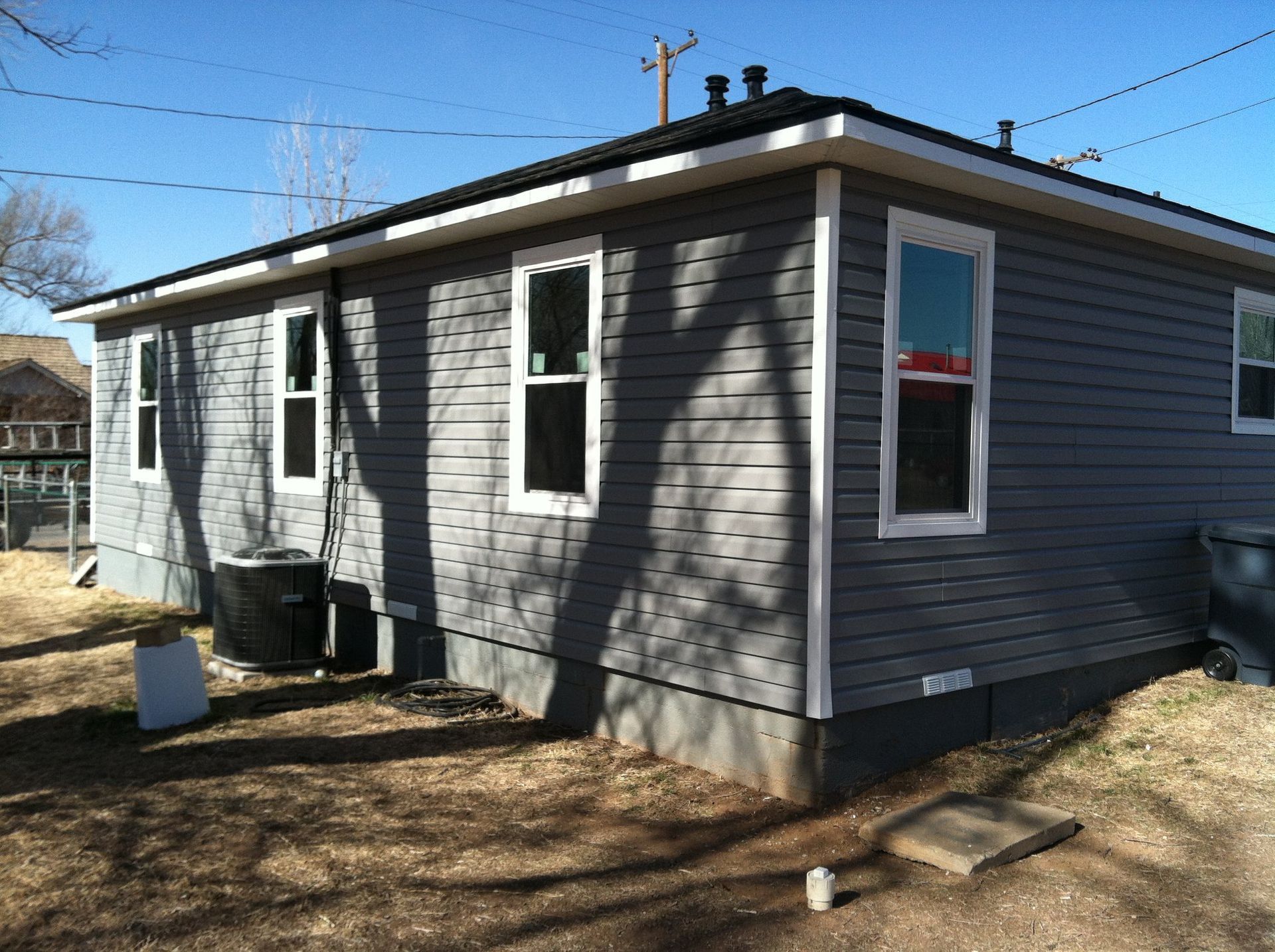 A small gray house with a lot of windows