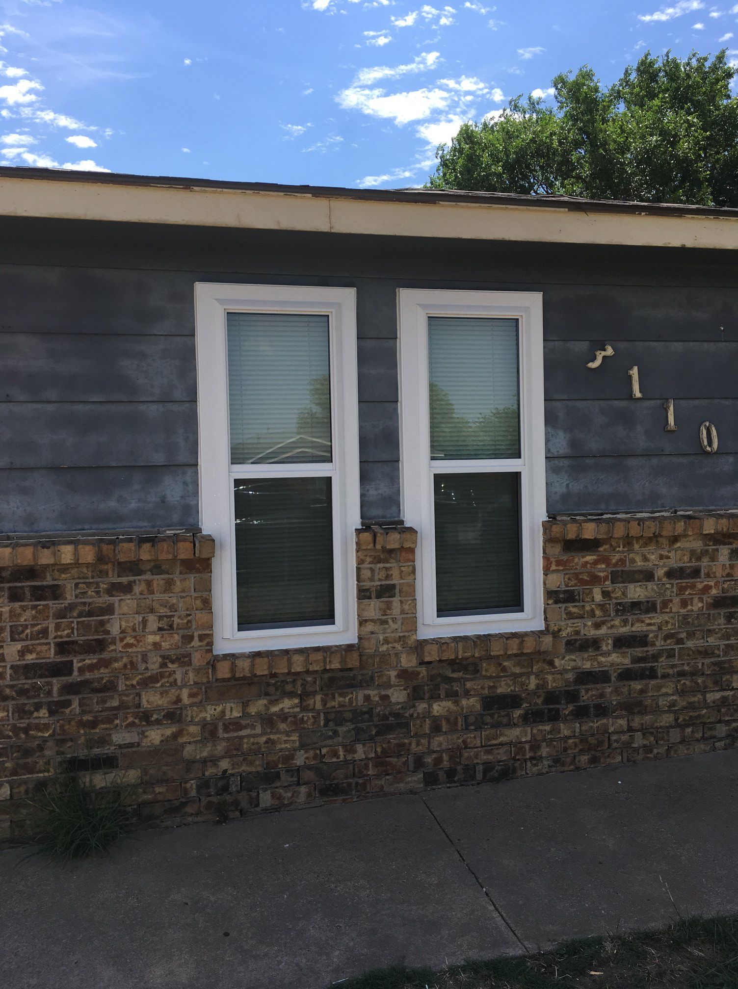 A house with two windows on the side of it